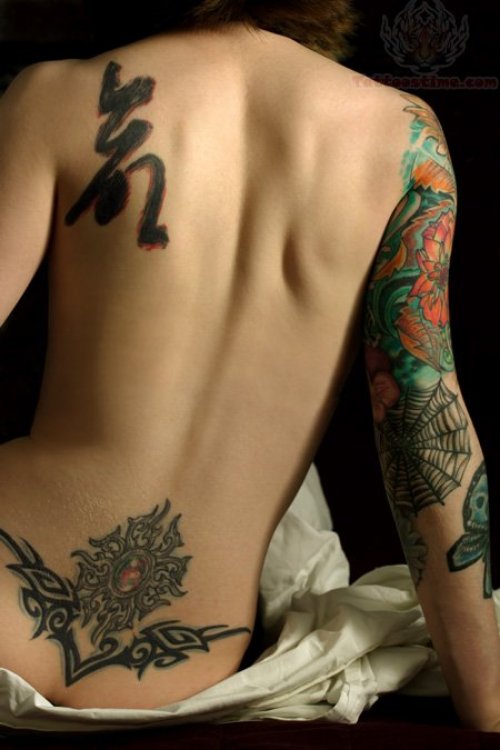 Tribal And Royal Stone Lower Back Tattoo